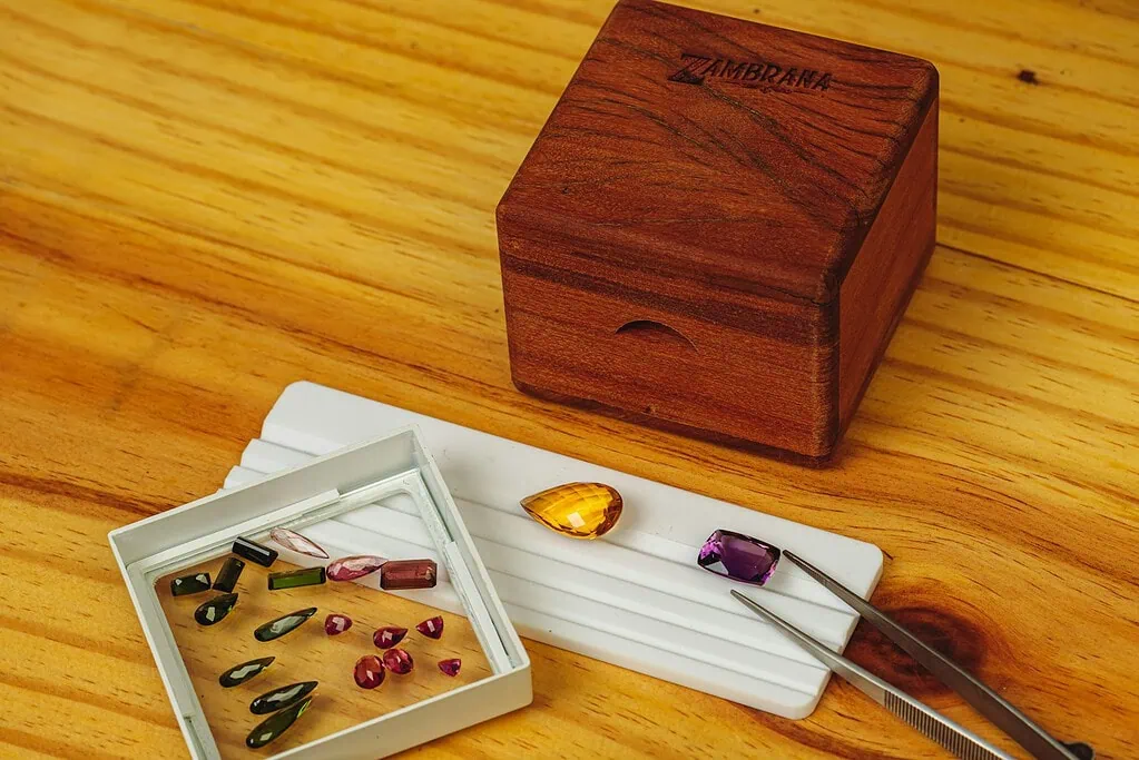 a wooden box sitting on top of a wooden table next to a pair of scissors